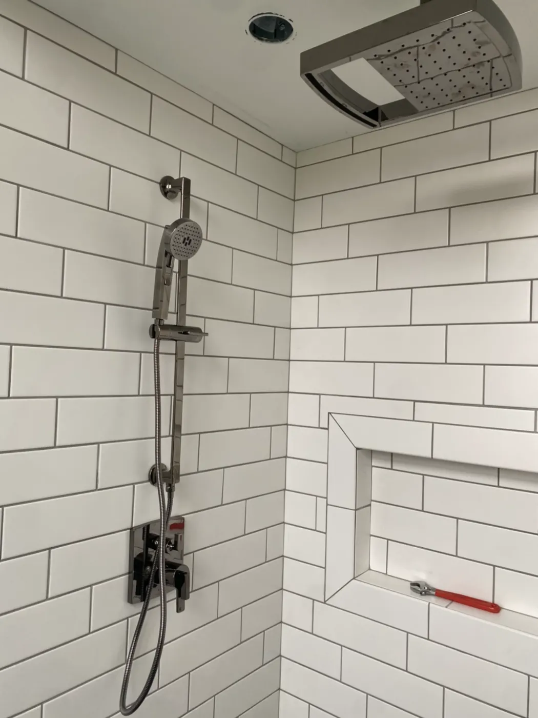 White subway tile shower with black fixtures