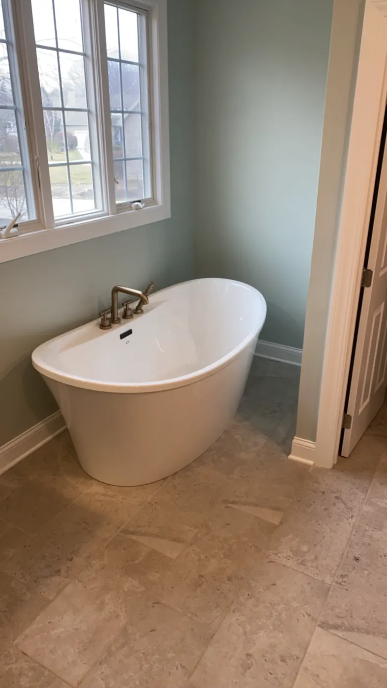 Freestanding soaking tub with a floor-mounted filler