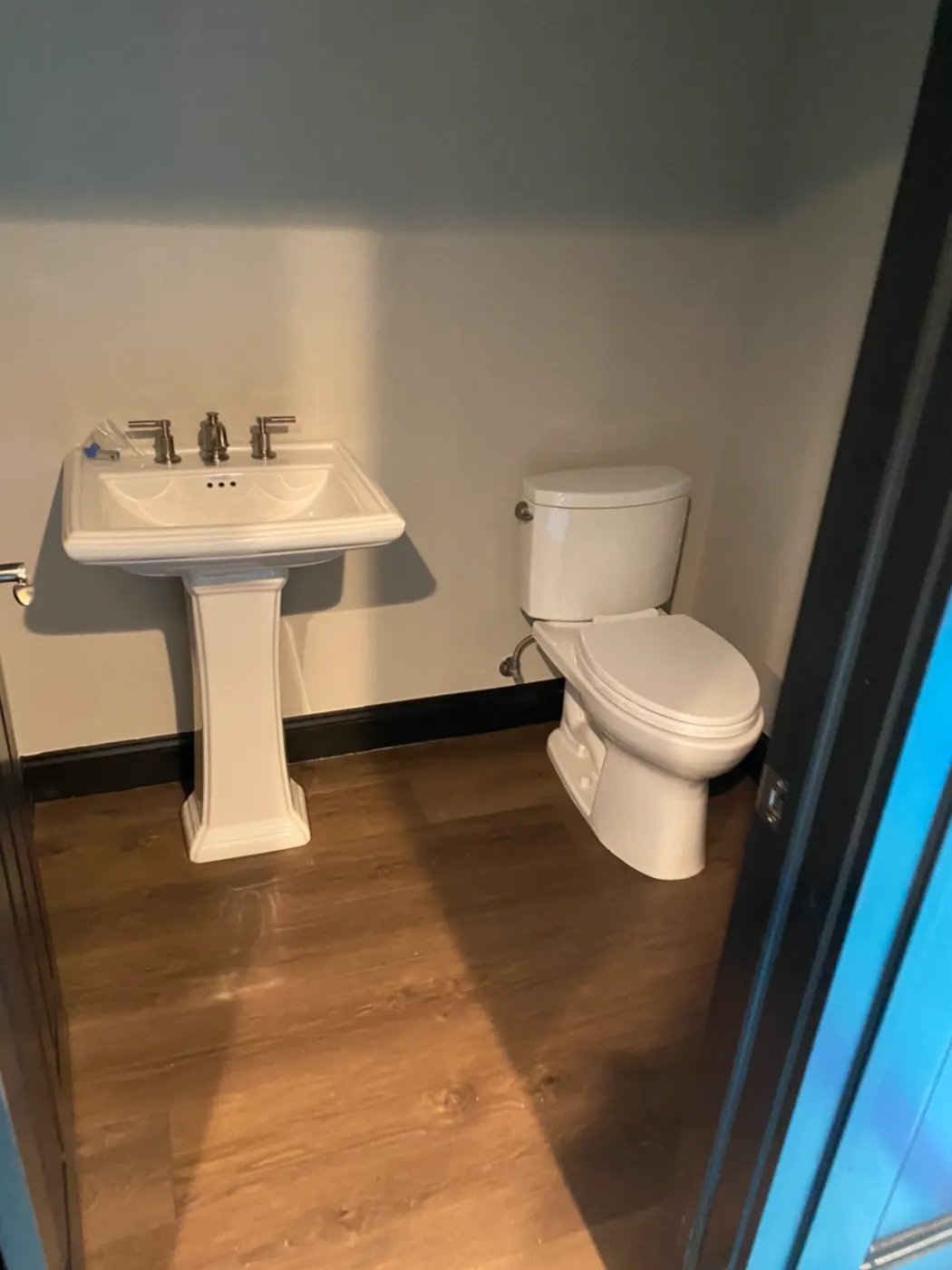 Pedestal sink and toilet in a finished half bath