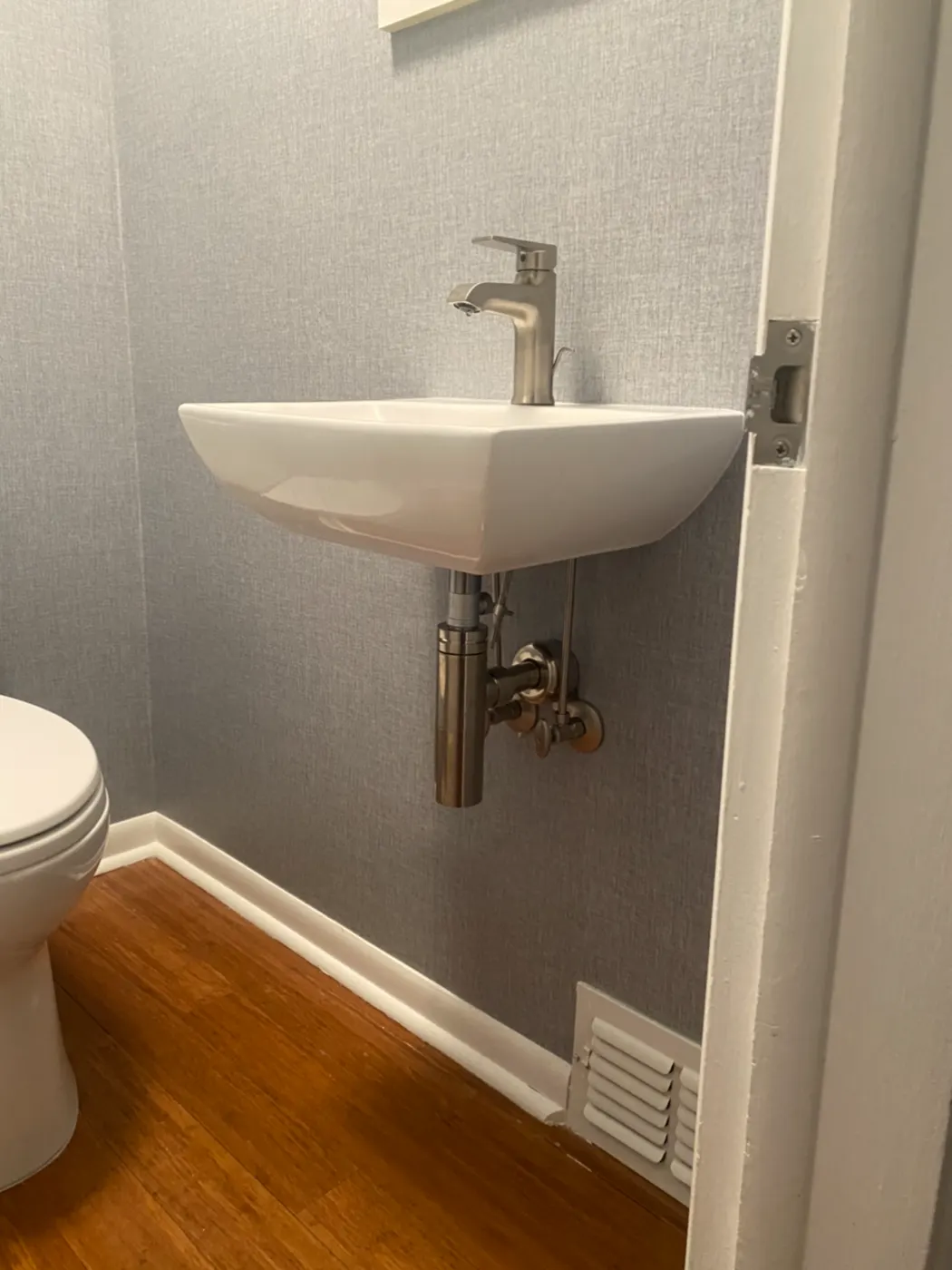 Wall-mounted sink in a small powder room
